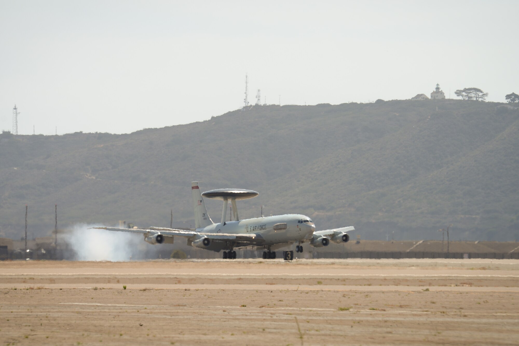 An E-3C Sentry Airborne Warning and Control System aircraft flown by reservists from the 513th Air Control Group touches down on Aug. 20 at Naval Air Station North Island in Coronado, Calif., after flying from its home station at Tinker Air Force Base, Okla. Maintenance and operations Airmen from the 513th are supporting naval operations by providing airborne command and control to ships and aircraft. (U.S. Air Force photo by Staff Sgt. Caleb Wanzer)