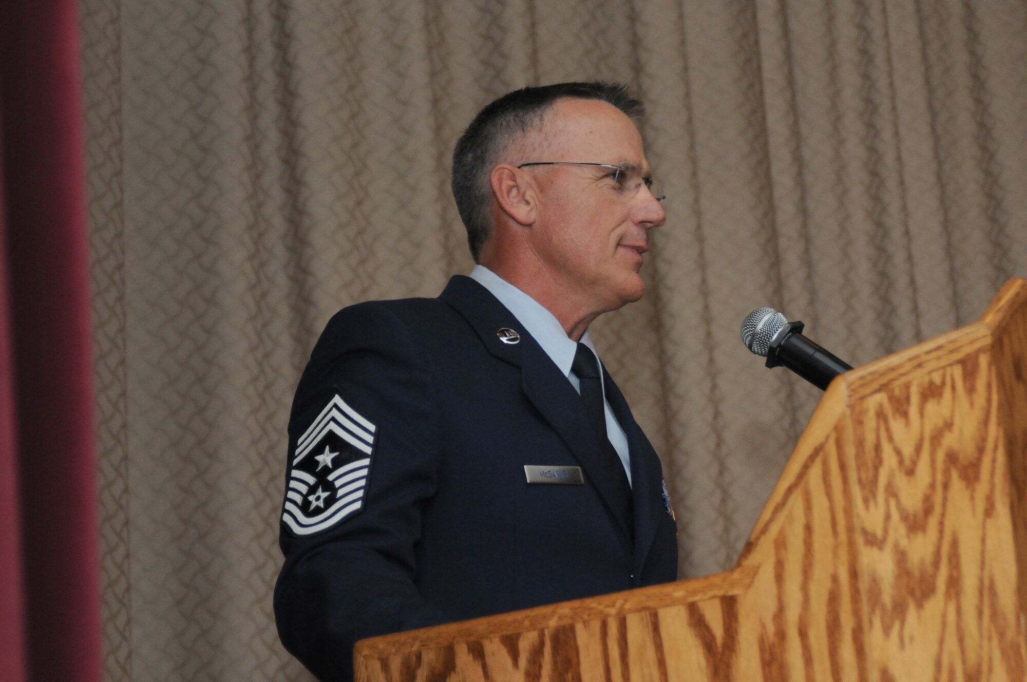 U.S. Air Force Chief Master Sgt. Mark McDaniel, 173rd Fighter Wing Command Chief, speaks to the crowd during a change of authority ceremony at Kingsley Field, Ore. Aug. 2, 2015.  McDaniel takes over as the top enlisted advisor for the 173rd FW from Chief Master Sgt. Danny Ross who served as the command chief since 2012.  (U.S. Air Force photo by Tech. Sgt. Jefferson Thompson/Released)