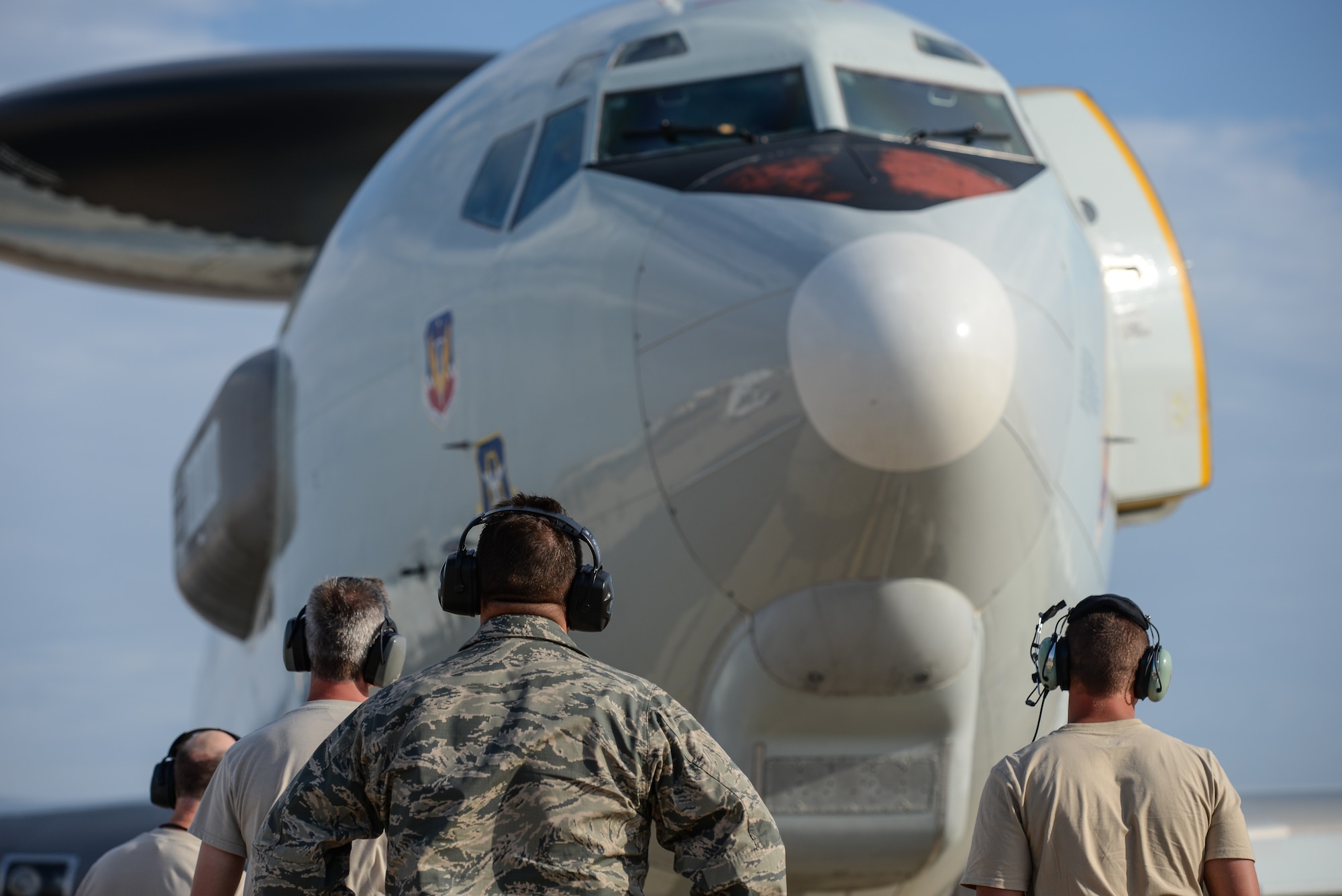 Maintenance Airmen from the 513th Air Control Group wait for an E-3C Sentry to complete shutdown procedures Aug. 24 after completing a training mission at Naval Air Station North Island in Coronado, Calif. The 513th maintenance reservists accompany every off-station training mission to provide routine checks as well as repairs if needed. (U.S. Air Force photo by Staff Sgt. Caleb Wanzer)