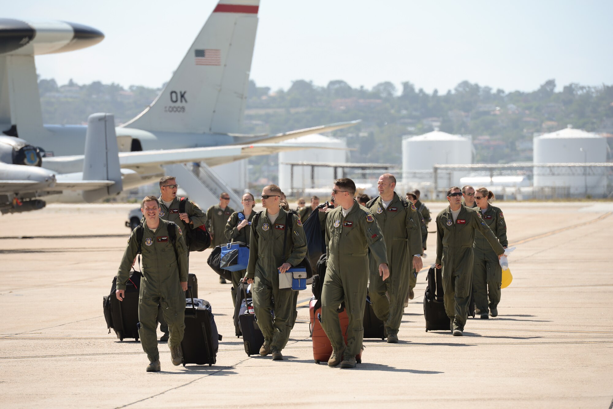 Airmen from the 513th Air Control Group and 552nd Air Control Wing walk off the flight line on Aug. 20 after landing at Naval Air Station North Island in Coronado, Calif. Reservists and active-duty operations Airmen flew missions together to provide airborne command and control to the U.S. Navy during Joint Task Force Exercise 2015. (U.S. Air Force photo by Staff Sgt. Caleb Wanzer)