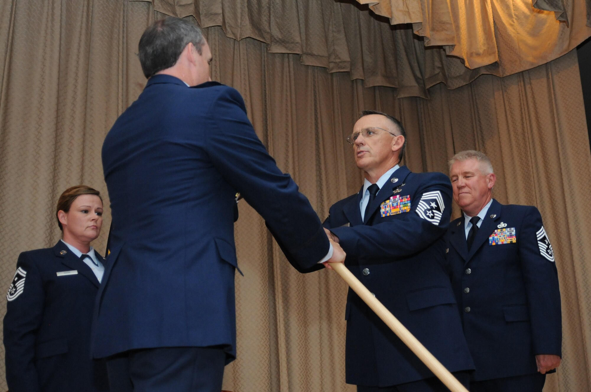 U.S. Air Force Col. Kirk Pierce, 173rd Fighter Wing Commander, passes the guideon to Chief Master Sgt. Mark McDaniel during a change of authority ceremony at Kingsley Field, Ore. Aug. 2, 2015.  McDaniel takes over as the top enlisted advisor for the 173rd FW from Chief Master Sgt. Danny Ross who served as the command chief since 2012.  (U.S. Air Force photo by Tech. Sgt. Jefferson Thompson/Released)