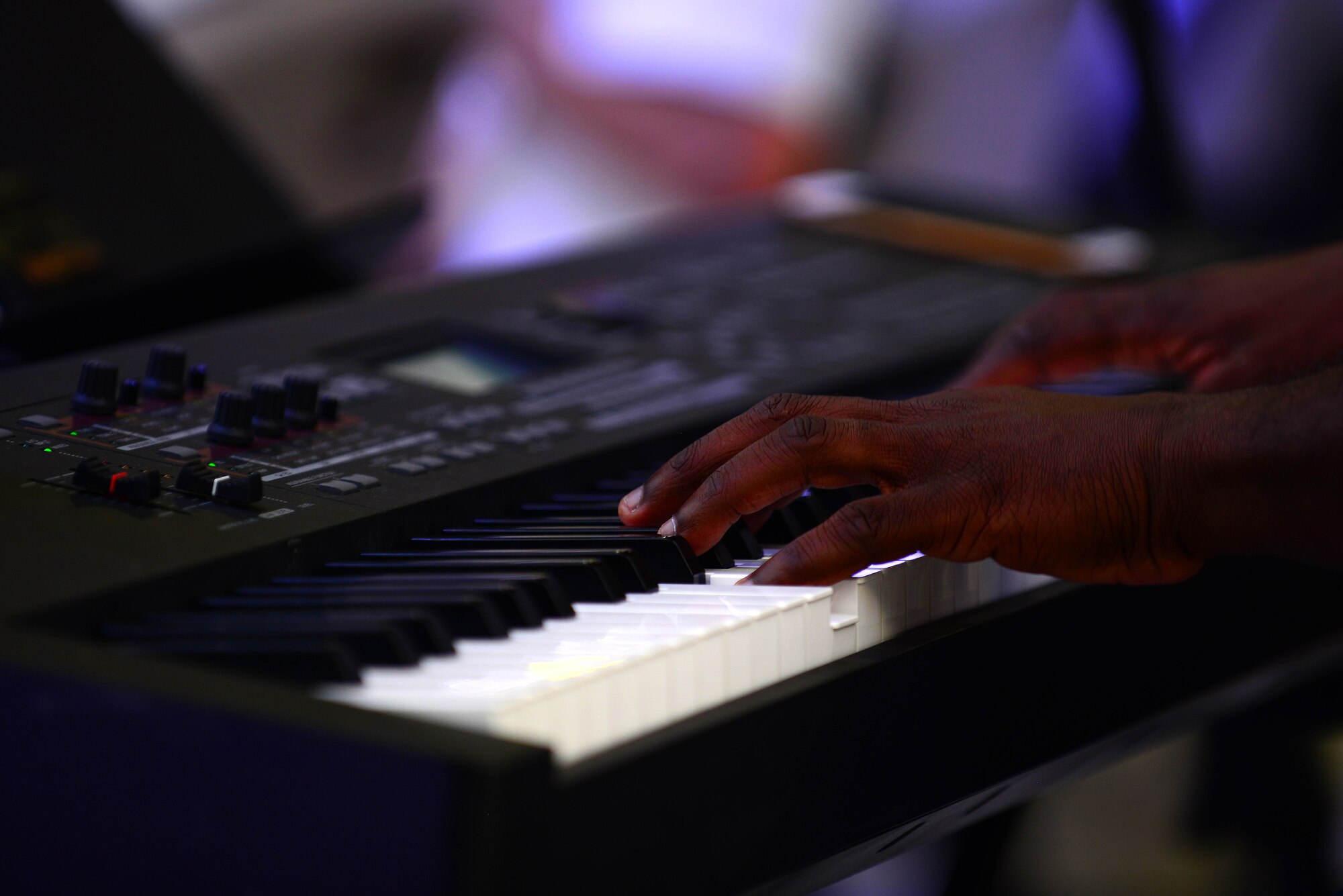 U.S. Army Sgt. Miguel Davis, U.S. Army Training and Doctrine Command Band member, plays the piano during the Tchaikovsky’s 1812 Overture concert at Fort Eustis, Va., Aug. 28, 2015. The show concluded their summer concert series of more than 10 performances, which featured the bands different styles of music. (U.S. Air Force photo by Senior Airman Kimberly Nagle/Released)