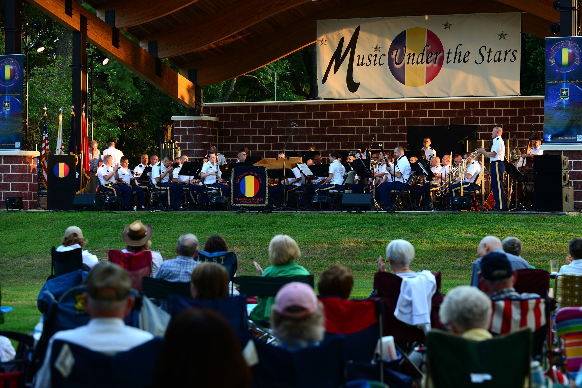 Music goers gather in Mangolia Park for the final summer concert series show “Music Under the Stars,” at Fort Eustis, Va., Aug. 28, 2015. The U.S. Army Training and Doctrine Command Band played songs such as “Liberty Bell” and “Stars and Stripes Forever,” by John Philip Susoa during the hour long performance. (U.S. Air Force photo by Senior Airman Kimberly Nagle/Released) 
