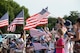 NAVAL AIR STATION FORT WORTH JOINT RESERVE BASE, Texas - Attendees of the Vietnam War 50th Anniversary Commemoration ‘Welcome Home’ event wave flags while watching the parade Aug. 1 at Veteran’s Park in White Settlement, Texas. The event, co-hosted by NAS Fort Worth JRB, included a parade, an official ceremony, and free food to honor veterans of the Vietnam War. (U.S. Air Force photo by Staff Sgt. Samantha A. Mathison)