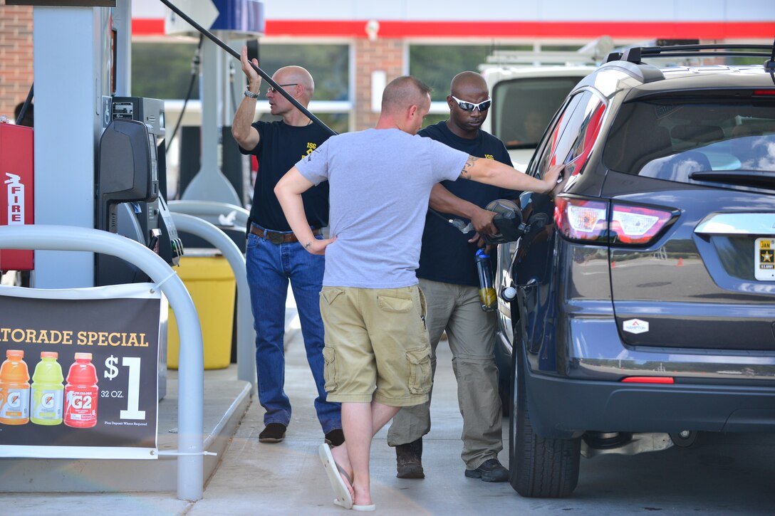 U.S. Army Master Sgt. Ernest Evans, right, Fort Eustis Diamond Council member, buys gas for Spc. Zebrey Oberlander, 73rd Transportation Company watercraft engineer, Aug. 28, 2015, at Fort Eustis, Va. The Joint Base Langley-Eustis Diamond Councils regularly conduct random acts of kindness around the installations to raise morale for Service members and their families. During this event, the counsel paid for $20 worth of gas for enlisted members E-5 and below. (U.S. Air Force photo by Staff Sgt. Natasha Stannard/Released)