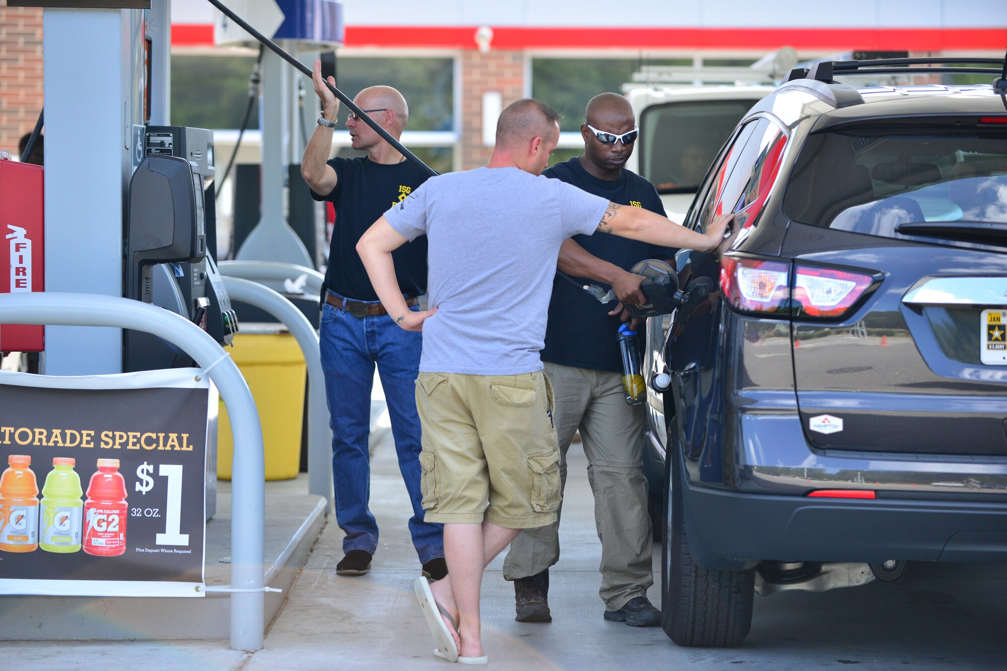 U.S. Army Master Sgt. Ernest Evans, right, Fort Eustis Diamond Council member, buys gas for Spc. Zebrey Oberlander, 73rd Transportation Company watercraft engineer, Aug. 28, 2015, at Fort Eustis, Va. The Joint Base Langley-Eustis Diamond Councils regularly conduct random acts of kindness around the installations to raise morale for Service members and their families. During this event, the counsel paid for $20 worth of gas for enlisted members E-5 and below. (U.S. Air Force photo by Staff Sgt. Natasha Stannard/Released)