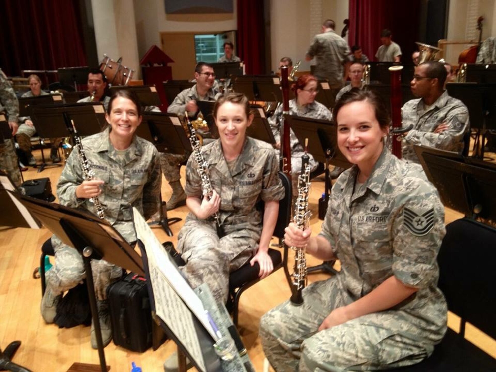(From left) Master Sgt. Tracey MacDonald and Technical Sgts Kaitlin Taylor and Emily Snyder pose during a break from a Concert Band rehearsal (photo by Master Sgt. Juliana Arnold/released).
