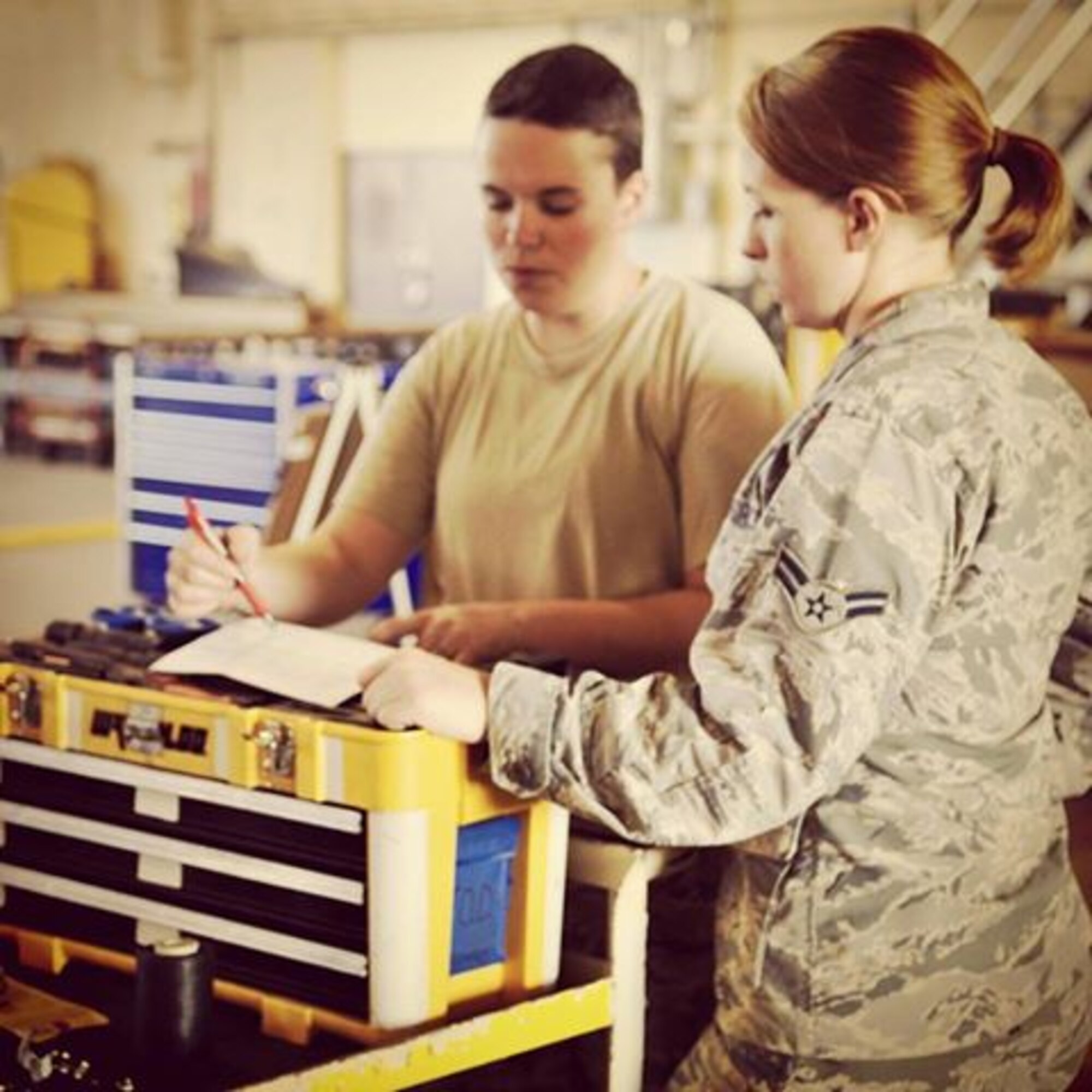 Rescue Reservists Senior Airman Rachel Coursey and Airman 1st Class Stephanie Long, communication navigation specialists at the 920th Rescue Wing, check technical orders for the HH-60G Pave Hawk helicopters. Reservists assigned to the 920 MXG constantly work on HH-60G Pave Hawk helicopters to aid in both the unit’s combat rescue and humanitarian mission. (U.S. Air Force photo/Tech Sgt. Abigail Klein)
