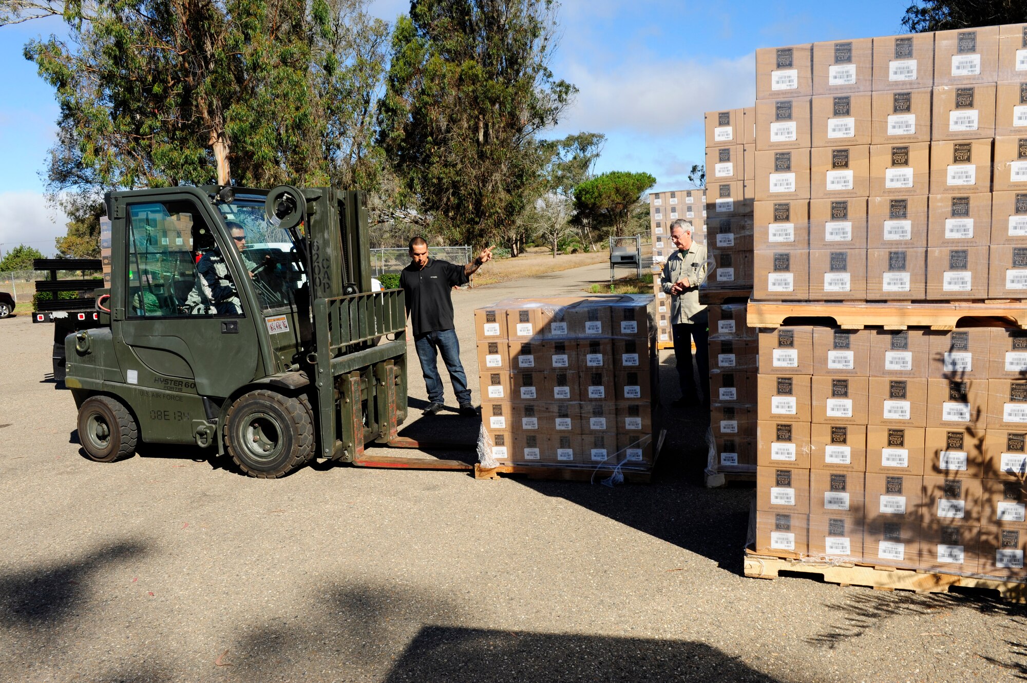 The 30th Logistics Readiness Squadron personnel distribute coffee during Operations Coffee Drop, Aug. 13, 2015, Vandenberg Air Force Base, Calif. The 30th SW chapel distributed 400,000 K-Cups to Team Vandenberg to improve morale and welfare. (U.S. Air Force photo by Staff Sgt. Jim Araos/Released)