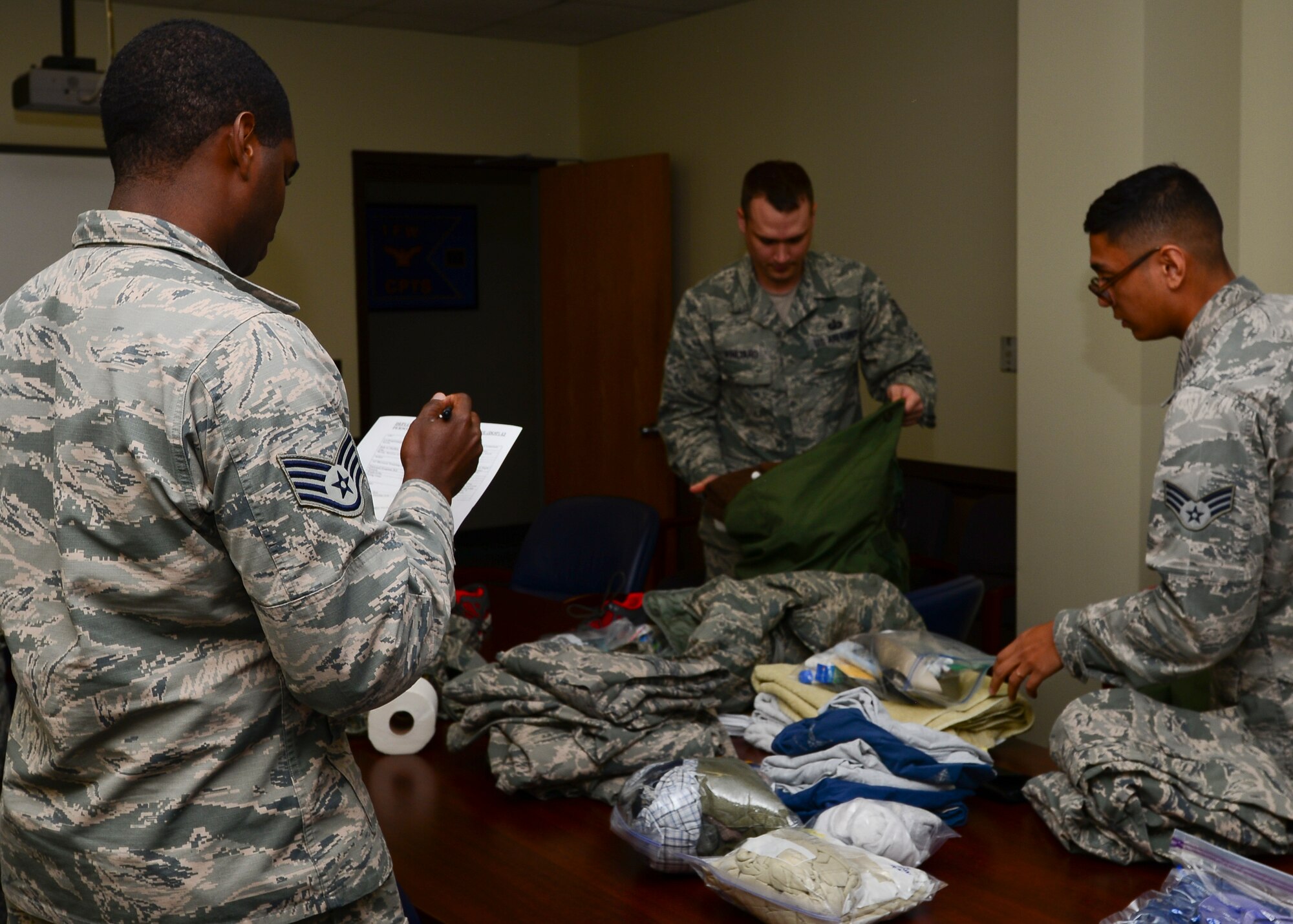 U.S. Air Force Staff Sgt. Paul Williams, 633rd Wing Staff Agency unit training manager, checks required items during a deployment readiness exercise at Langley Air Force Base, Va., Aug 27, 2015. The exercise was part of an initiative directed by the 9th Air Force to test each of its subordinate wing’s capability to rapidly deploy to support combatant commanders across the globe and ensure the unit’s Airmen are ready when called upon. (U.S. Air Force photo by Airmen 1st Class Derek Seifert/ Released)