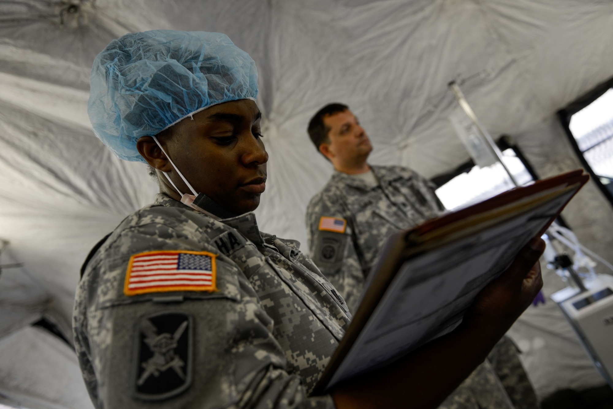 U.S. Army Capt. Taiasha Haywood, 160th Forward Surgical Team perioperative officer in charge, checks a chart while her team cares for a simulated patient Aug. 25, 2015, at Ramstein Air Base, Germany. The 160th FST participated in “role two” of the exercise, which involved immediate treatment so the patient can be safely escorted to a larger medical facility. (U.S. Air Force photo/Senior Airman Nicole Sikorski)