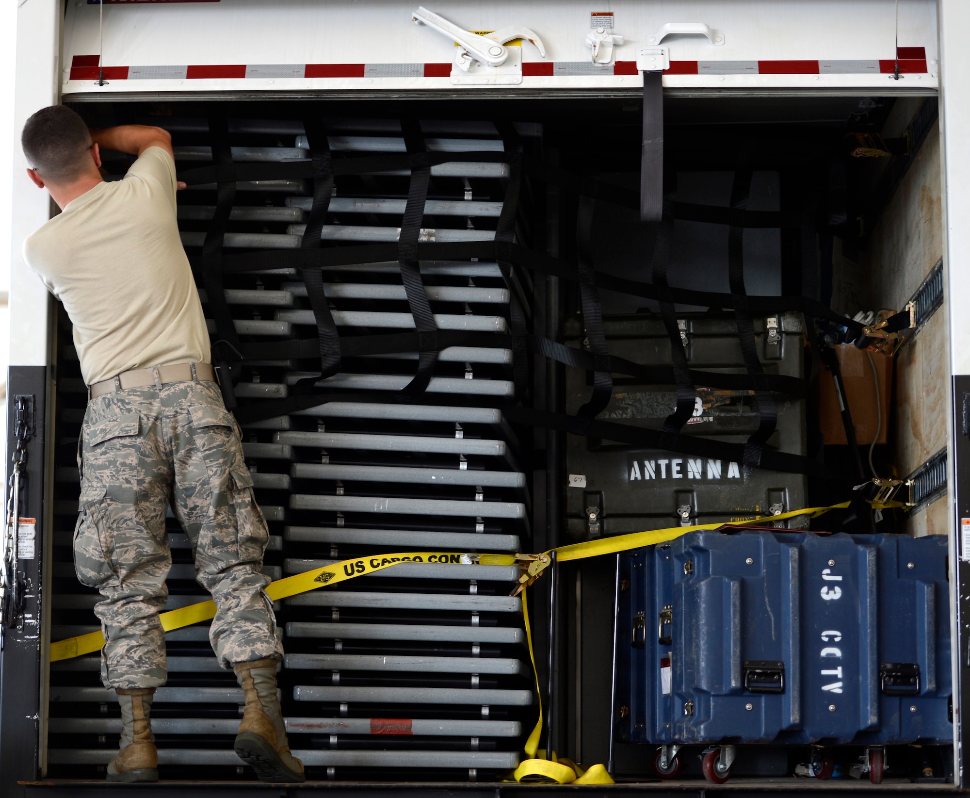 U.S. Air Force Senior Airman Jacob Werdefoff, 633rd Logistics Readiness Squadron joint inspector, secures cargo inside of a government-owned vehicle at Langley Air Force Base, Va., Aug. 25, 2015. The Phase I Deployment Readiness Exercise was part of an initiative directed by 9th Air Force to test the capabilities to rapidly deploy within short notice.  (U.S. Air Force photo by Senior Airman Kayla Newman/Released)
