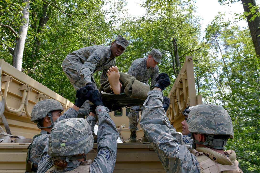 Medical responders lift a simulated patient into a truck after treating him during a medical evacuation exercise Aug. 25, 2015, at Ramstein Air Base, Germany.  Airmen and Soldiers from around the Kaiserslautern Military Community gathered for the three-part exercise to show visiting NATO officers the capabilities of the U.S. Air Force and Army. (U.S. Air Force photo/Senior Airman Nicole Sikorski)