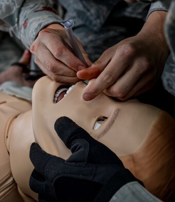 Medical responders place a nasopharyngeal airway into a simulated patient’s nose during a medical evacuation exercise Aug. 25, 2015, at Ramstein Air Base, Germany.  Airmen and Soldiers from around the Kaiserslautern Military Community keep current with training on medical and casualty evacuation regardless of their job titles. (U.S. Air Force photo/Senior Airman Nicole Sikorski)