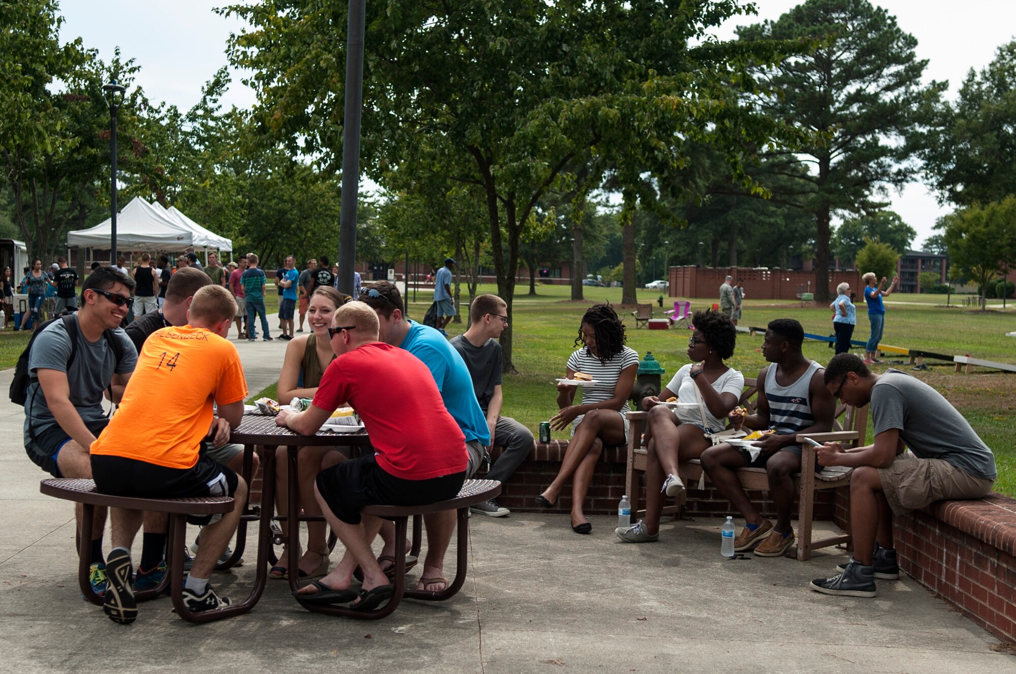 Dorm Airmen talk and eat during the Summer Music Fest, Aug. 29, 2015, at Seymour Johnson Air Force Base, North Carolina. More than 130 dorm residents were treated to free food, games and music during the event to help enhance their social and spiritual pillars of resilience. (U.S. Air Force photo/Airman 1st Class Shawna L. Keyes)