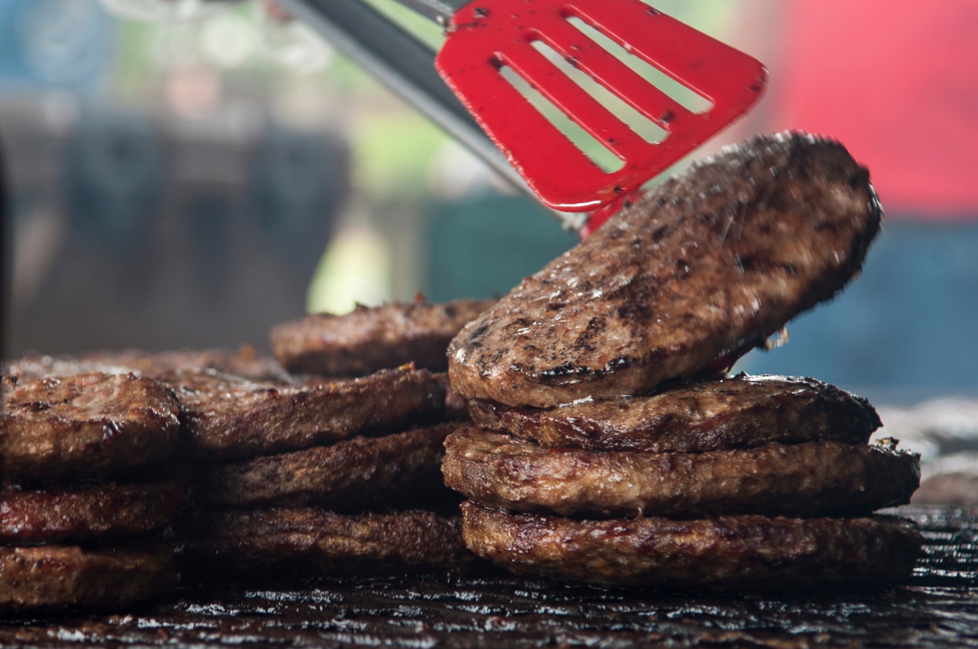 Mike Jones, a volunteer from a local church, prepares burgers during the Summer Music Fest, Aug. 29, 2015, at Seymour Johnson Air Force Base, North Carolina. The event, which featured live music, games and food, provided Airmen the opportunity to socially interact with each other and different church organizations within the local community. (U.S. Air Force photo/Airman 1st Class Shawna L. Keyes)
