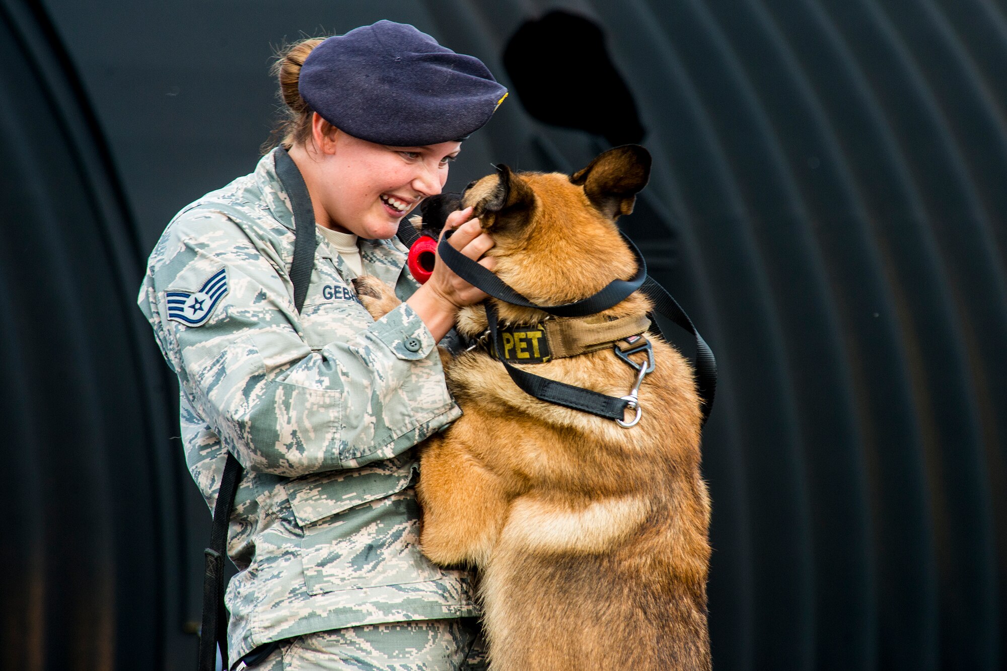 U.S. Air Force Staff Sgt. Lyndsay Gebhart, 23d Security Forces Squadron military working dog handler, praises MWD Nido Aug. 26, 2015, at Moody Air Force Base, Ga. Gebhart rewarded Nido with a chew toy for locating a trained substance. (U.S. Air Force photo by Airman 1st Class Ceaira Tinsley/Released)