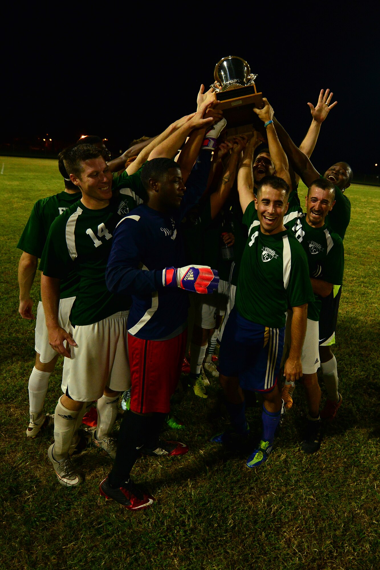 Langley All Star players raise the championship cup after winning the Joint Base Langley-Eustis intramural soccer championship Aug. 26, 2015, at Fort Eustis, Va. After going into overtime with the Fort Eustis All Stars, the Langley All Stars won 4-2. (U.S. Air Force photo by Staff Sgt. Natasha Stannard/Released)