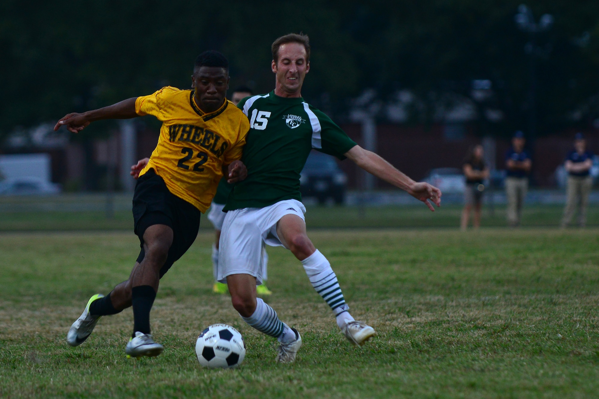 U.S. Army Pfc. Tiphine Torbo, Fort Eustis All Star player, and U.S. Air Force Staff Sgt. Daniel Pelrine, Langley All Star player, scramble for the ball during the Joint Base Langley-Eustis intramural soccer championship Aug. 26, 2015, at Fort Eustis, Va. After playing 90 minutes, the teams went into overtime playing an additional 30 minutes to break a tie. (U.S. Air Force photo by Staff Sgt. Natasha Stannard/Released)