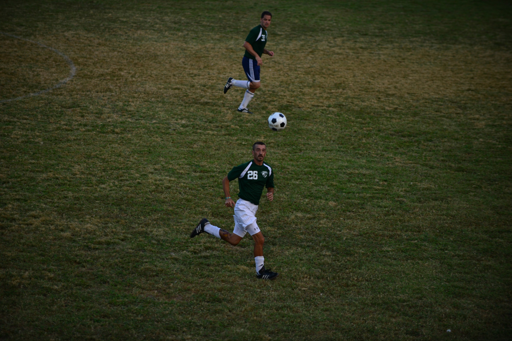Langley All Star players Jose Gomez, right, and U.S. Air Force Maj. Javier Padial chase the ball during the Joint Base Langley-Eustis intramural soccer championship Aug. 26, 2015, at Fort Eustis, Va. The team’s scores stayed close throughout the game until going into overtime, during which the Langley All Stars scored two goals. (U.S. Air Force photo by Staff Sgt. Natasha Stannard/Released)