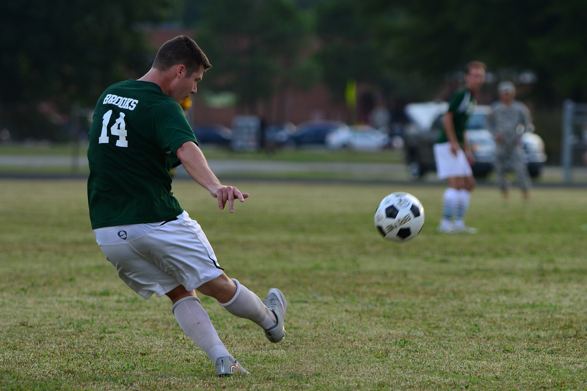 U.S. Air Force Senior Airman Bradford Brooks, Langley All Stars soccer player, kicks the ball to a team member during the Joint Base Langley-Eustis intramural soccer championship Aug. 26, 2015, at Fort Eustis, Va. Brooks and fellow teammates switched positions throughout the game because the team was made-up of nominated players, some of whom play the same positions, from various Langley soccer teams. (U.S. Air Force photo by Staff Sgt. Natasha Stannard/Released)