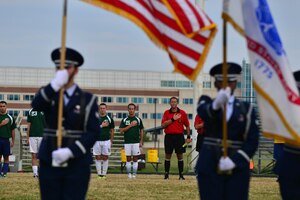 Players honor the U.S. flag during a rendition of the National Anthem before the Joint Base Langley-Eustis intramural soccer championship Aug. 26, 2015, at Fort Eustis, Va. The game marked the first JBLE sports championship between the top Fort Eustis and Langley Air Force Base players. (U.S. Air Force photo by Staff Sgt. Natasha Stannard/Released)
