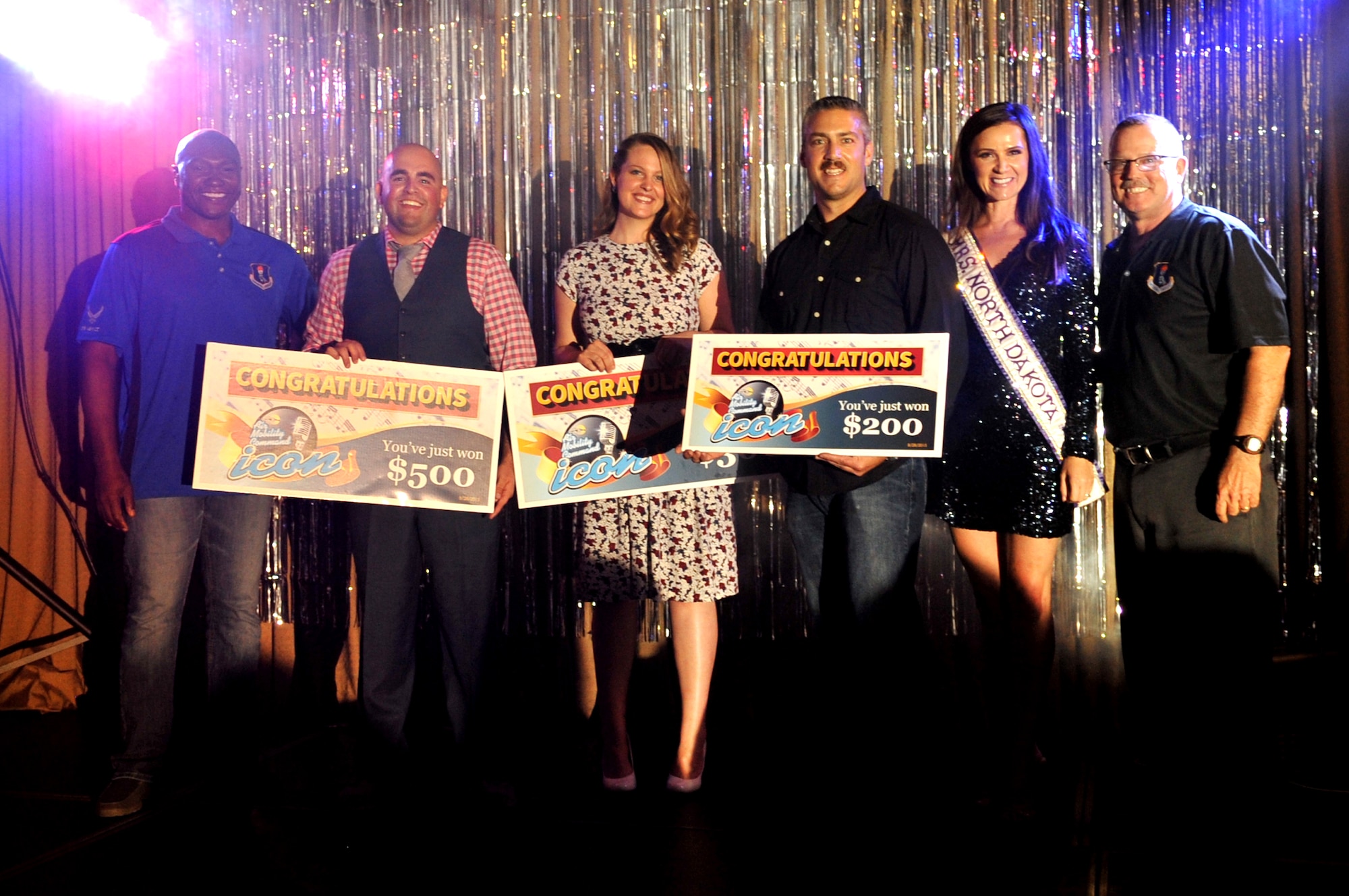 The top three contestants from the 2015 AMC Icon competition are pictured with Col. Rodney Lewis (left), Erin Bertel, Mrs. North Dakota International 2015, and Chief Master Sgt. David Duncan, 319th Air Base Wing command chief master sergeant. Contestants were judged on technical excellence and showmanship, with the top performer being chosen to advance to Command Finals at Scott Air Force Base, Ill. (U.S. Air Force photo/Staff Sgt. Susan L. Davis)