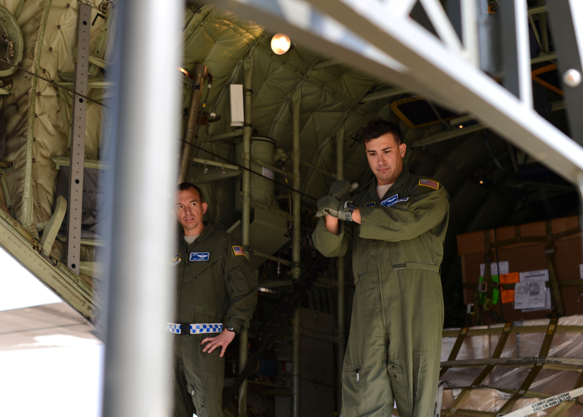 U.S. Air Force Tech. Sgt. Justin Adams, 37th Airlift Squadron loadmaster, Ramstein Air Base, Germany, directs a container transporter, Aug. 28, 2015, at Aviano Air Base, Italy. Aviano receives everything from nuts and bolts to F-16 Fighting Falcon wings during routine cargo uploads and downloads. (U.S. Air Force photo by Senior Airman Austin Harvill/Released)