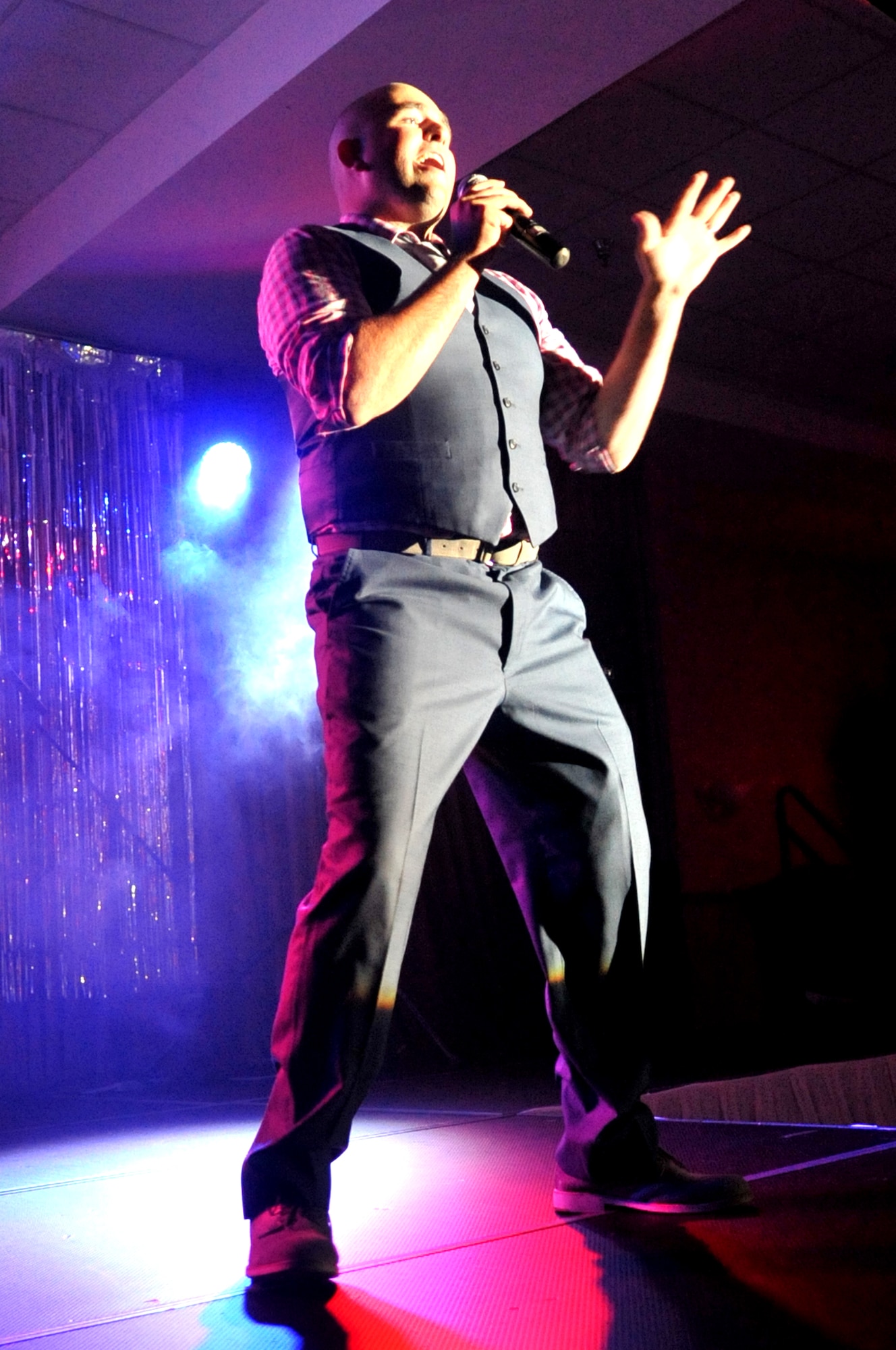 Airman 1st Class Ryan Sparks, 319th Air Base Wing Public Affairs, sings Michael Buble’s “Feeling Good” Aug. 28, 2015 at the AMC Icon competition on Grand Forks Air Force Base, North Dakota. Sparks took home the grand prize of $500 with his rendition of the song, and will go on to perform at Scott Air Force Base, Ill., for a chance at $1,000 against performers from other AMC bases. (U.S. Air Force photo/Staff Sgt. Susan L. Davis)