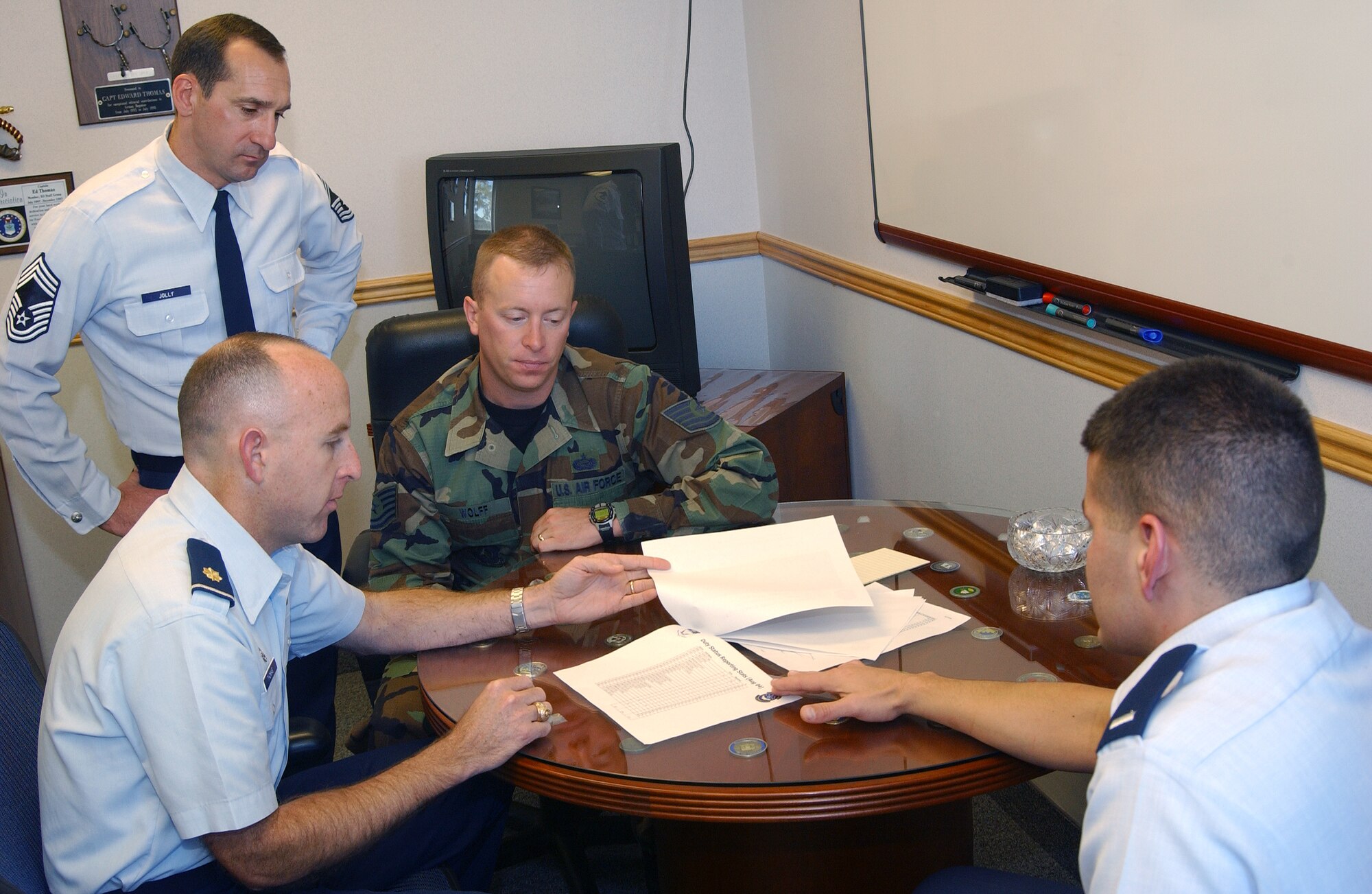 Leadership from the former 341st Mission Support Squadron, currently the 341st Force Support Squadron, under the 341st Mission Support Group, review manpower tracking documents at Malmstrom Air Force Base, Mont., Oct. 7, 2004. The 341st MSG is celebrating its 60th anniversary since it was established as the 341st Air Base Group at Abilene AFB, Texas, Sept. 1, 1955. (U.S Air Force photo/Roger Dey)
