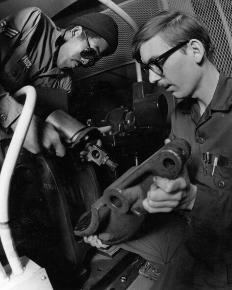 Sgt. Robert Price, left, and Airman First Class Timothy Maloney, 341st Civil Engineer Squadron, as part of the then 341st Combat Support Group, tighten a bolt on a brake shoe and magnetic core assembly for a launch control facility elevator drive unit at Malmstrom Air Force Base, Mont., in 1980. The 341st CSG was re-designated the 341st Mission Support Group in 2002 and the group  is celebrating its 60th anniversary since it was established as the 341st Air Base Group at Abilene AFB, Texas, Sept. 1, 1955.  (U.S. Air Force photo)