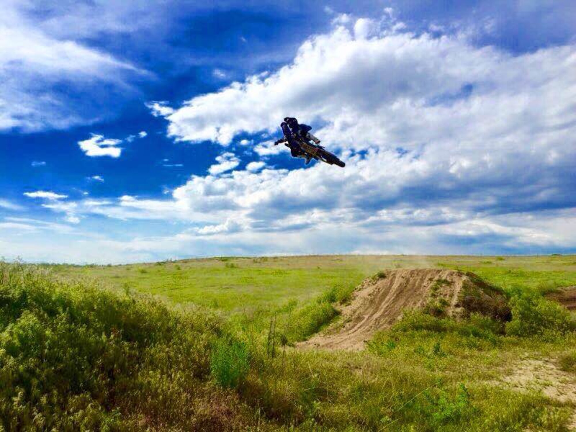 Senior Airman Zach Buccieri, 22nd Maintenance Squadron aircraft hydraulics specialist, practices jumping ramps on a dirt bike, July, 2015, in Bennett, Colo. Riding dirt bikes has been a hobby, form of expression and way of life for Buccieri. (Courtesy photo)