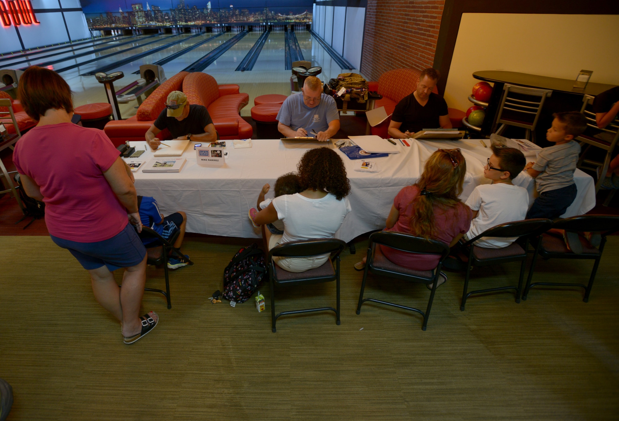 National Cartoonist Society members draw caricatures for military members, their dependents, and civilian contractors during a USO tour Aug. 27, 2015, at Incirlik Air Base, Turkey.  The cartoonists visited military members in Kuwait, Africa and Turkey as part of the USO tour. (U.S. Air Force photo by Senior Airman Krystal Ardrey/Released)