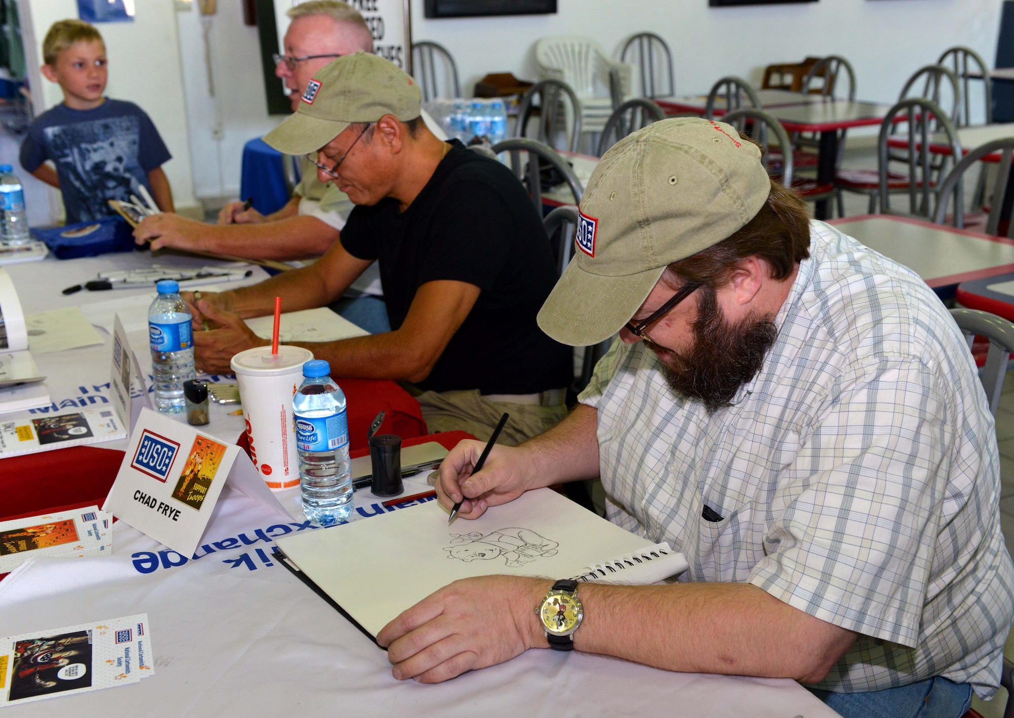 Chad Frye, a National Cartoonist Society member on tour with the USO, sketches an animated character Aug. 26, 2015, at Incirlik Air Base, Turkey. Incirlik was the last stop on a three-country USO tour that also visited troops in Kuwait and Africa. (U.S. Air Force photo by Senior Airman Michael Battles/Released)