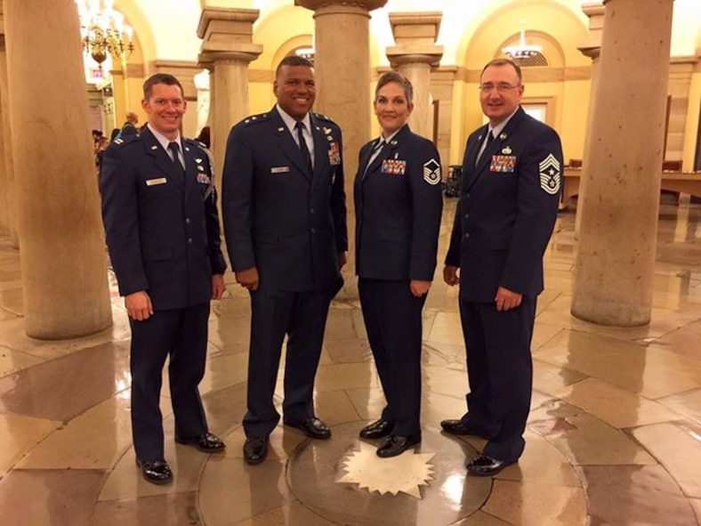 (Left) Capt. Brandon Wheeler, 8th Air Force commander’s executive assistant, Maj. Gen. Richard Clark, 8th Air Force commander, Master Sgt. Nancy Auger, 5th Medical Group acting first sergeant,  and Chief Master Sgt. Marty Anderson, 8th Air Force command chief, pose for a group photo on Capitol Hill, July 22, 2015. They were standing in the Capitol Building Crypt, and the star on the floor denotes the point from which the streets in Washington are laid out and numbered. Clark wanted to take an annual award winner with him during his visit to Capitol Hill, and Auger said she was fortunate enough they selected to bring the SNCO of the Year. The trip is an annual occurrence for the 8th Air Force commander and command chief. (Courtesy photo)  