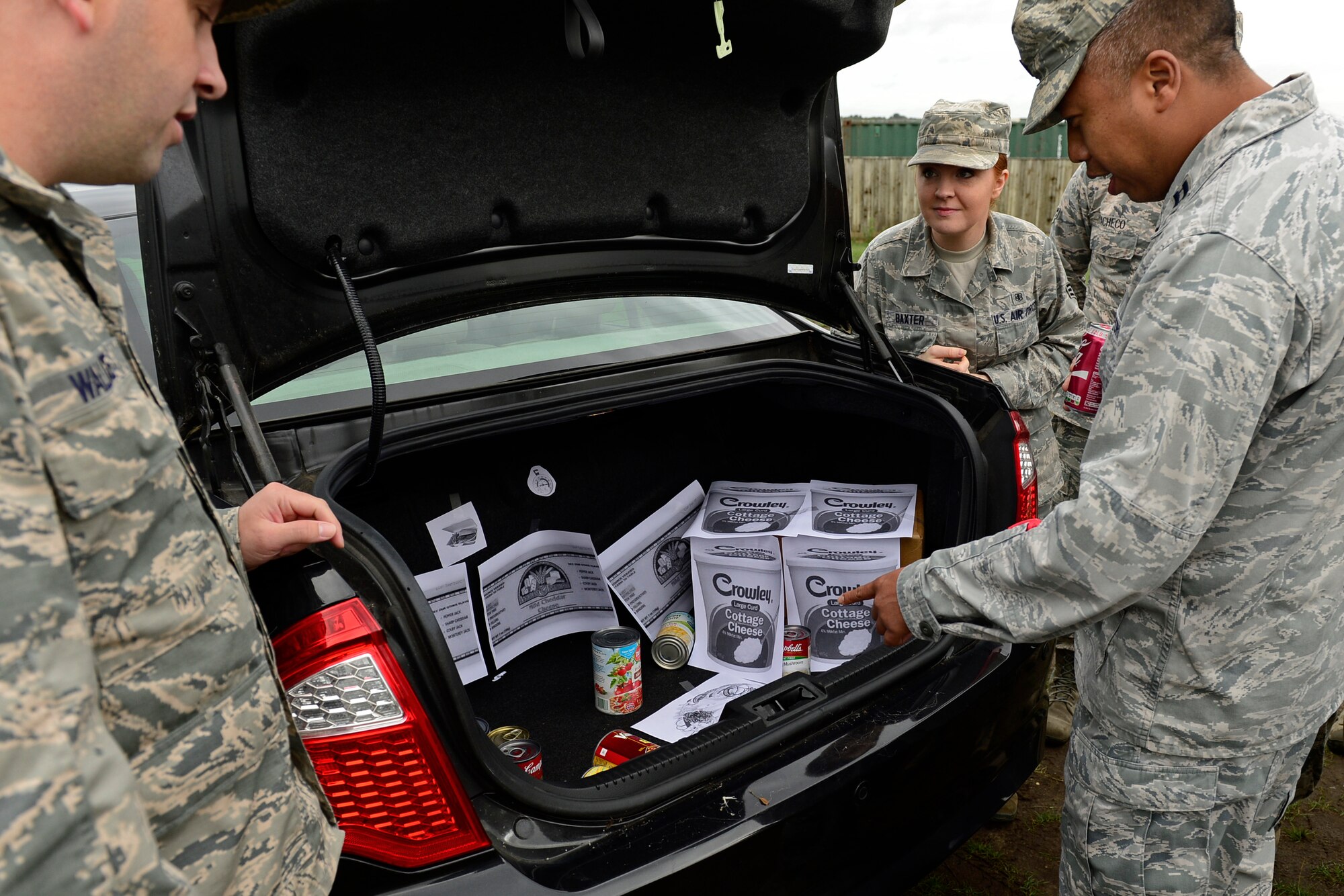 Airmen from the 48th Aerospace Medicine Squadron inspect a simulated food delivery to find any notable discrepancies during Preventive Environmental Sustainment Training, a two day training event, at Royal Air Force Lakenheath, England, Aug. 27, 2015. This was the third year the 48th AMDS conducted training which entailed practical application of different areas of public health and bioenvironmental engineering to perform bare base setup operations. (U.S. Air Force photo by Airman 1st Class Erin R. Babis/Released)