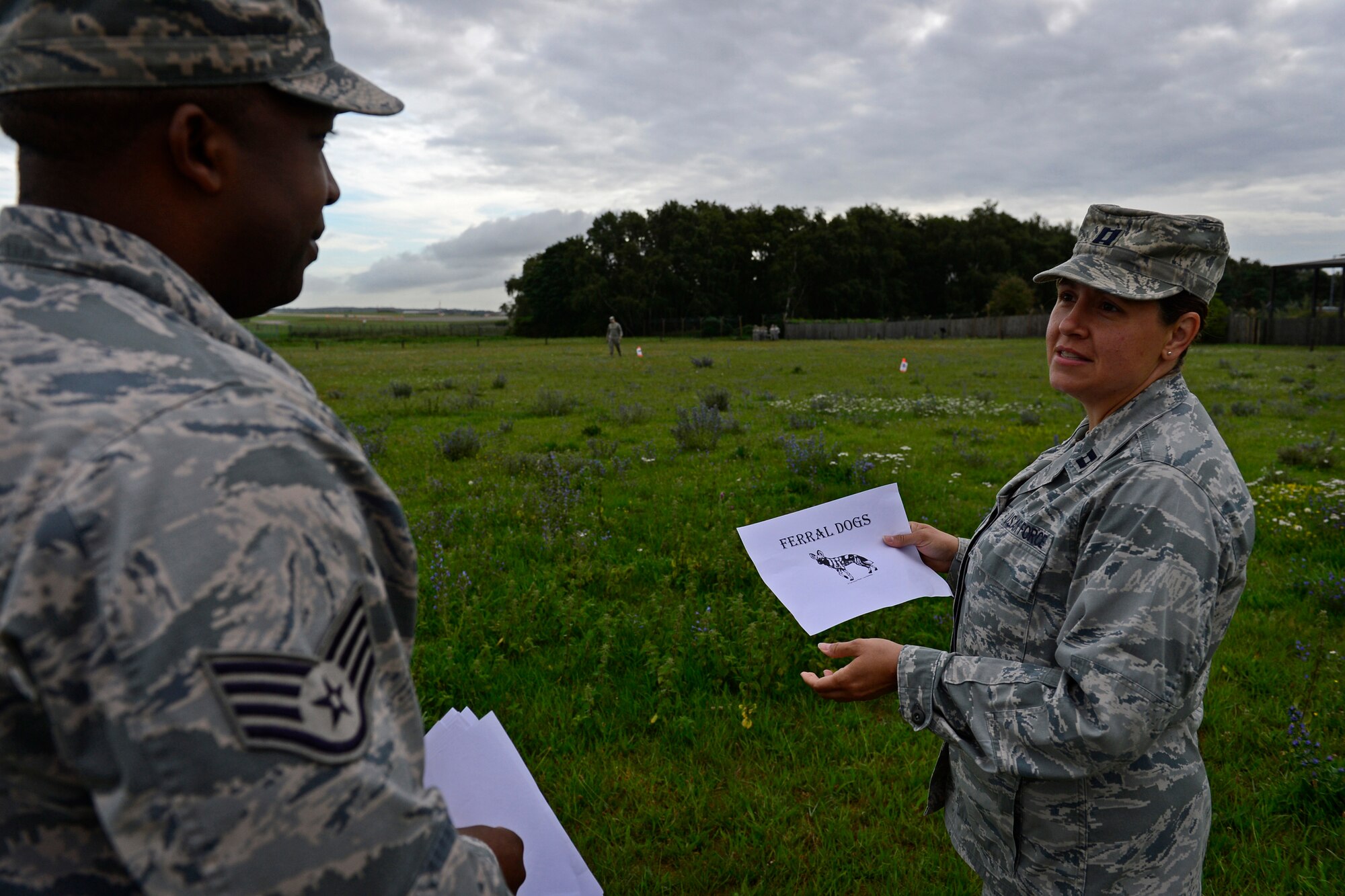 Capt. Karen Vandor, 48th Aerospace Medicine Squadron chief of community health, and Staff Sgt. Carlton Cooper, 48th AMDS public health technician, discuss proper placement of facilities for a bare base operation during Preventive Environmental Sustainment Training, a two-day training event, at Royal Air Force Lakenheath, England, Aug. 27, 2015. PESTFEST was developed for Public Health and Bioenvironmental Engineering flights to conduct hands-on readiness training in preparation to perform bare base operations. (U.S. Air Force photo by Airman 1st Class Erin R. Babis/Released)