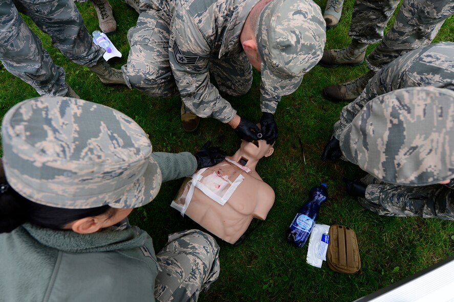 Airmen from the 48th Aerospace Medicine Squadron practice Self Aid Buddy Care during Preventive Environmental Sustainment Training, a two-day training event, at Royal Air Force Lakenheath, England, Aug. 27, 2015. This was the third year the 48th AMDS conducted training which entailed practical application of different areas of public health and bioenvironmental engineering to perform bare base setup operations. (U.S. Air Force photo by Airman 1st Class Erin R. Babis/Released)