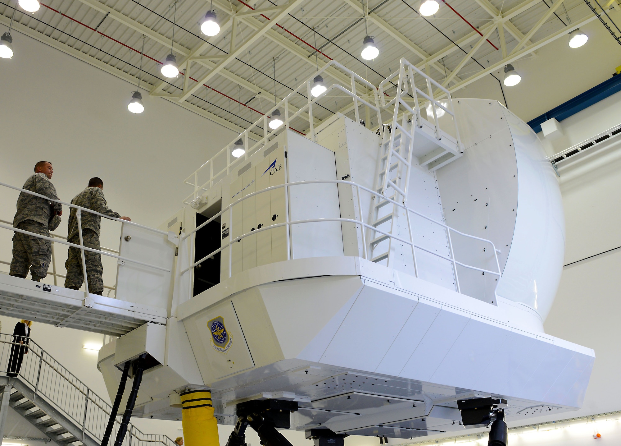 Members of the Kaiserslautern Military Community tour the new C-130J Super Hercules Flight Simulator facility Aug. 24, 2015, at Ramstein Air Base, Germany. The simulator will allow maintenance personnel to practice engine-run training and memorization with the cockpit for integration with flightline operations. (U.S. Air Force photo/Senior Airman Timothy Moore)