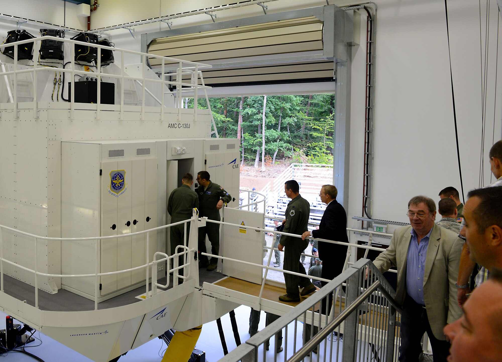 Members of the Kaiserslautern Military Community tour the new C-130J Super Hercules Flight Simulator facility Aug. 24, 2015, at Ramstein Air Base, Germany. The simulator will allow maintenance personnel to practice engine-run training and memorization with the cockpit for integration with flightline operations. (U.S. Air Force photo/Senior Airman Timothy Moore)