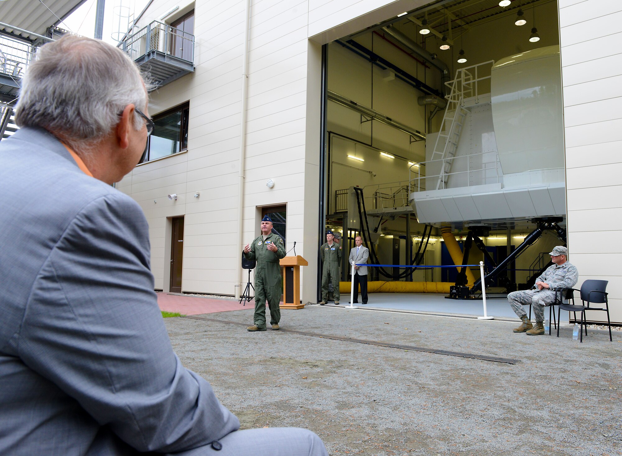 Col. Eric Mayheu, Air Mobility Command Aircrew Operations and Training Division chief, speaks during the ribbon cutting ceremony for the C-130J Super Hercules Flight Simulator Aug. 24, 2015, at Ramstein Air Base, Germany. The project is a result of a collaborative effort, as the simulator itself is owned by AMC but housed in a U.S. Air Forces in Europe and 86th Airlift Wing building. (U.S. Air Force photo/Senior Airman Timothy Moore)
