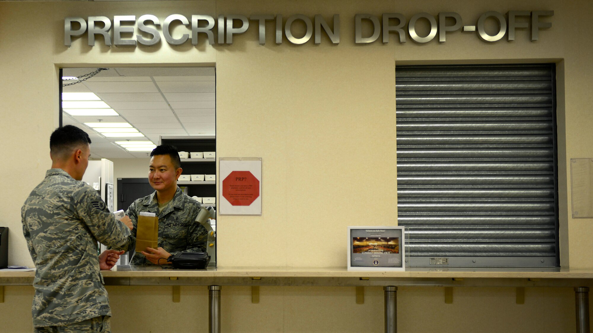 U.S. Air Force Staff Sgt. Charles Shin, 31st Medical Support Squadron Pharmacy technician, gives a patient their prescription, Aug. 31, 2015, at Aviano Air Base, Italy. The pharmacy fills more than 200 prescriptions a day. (U.S. Air Force photo by Senior Airman Areca T. Wilson/Released)