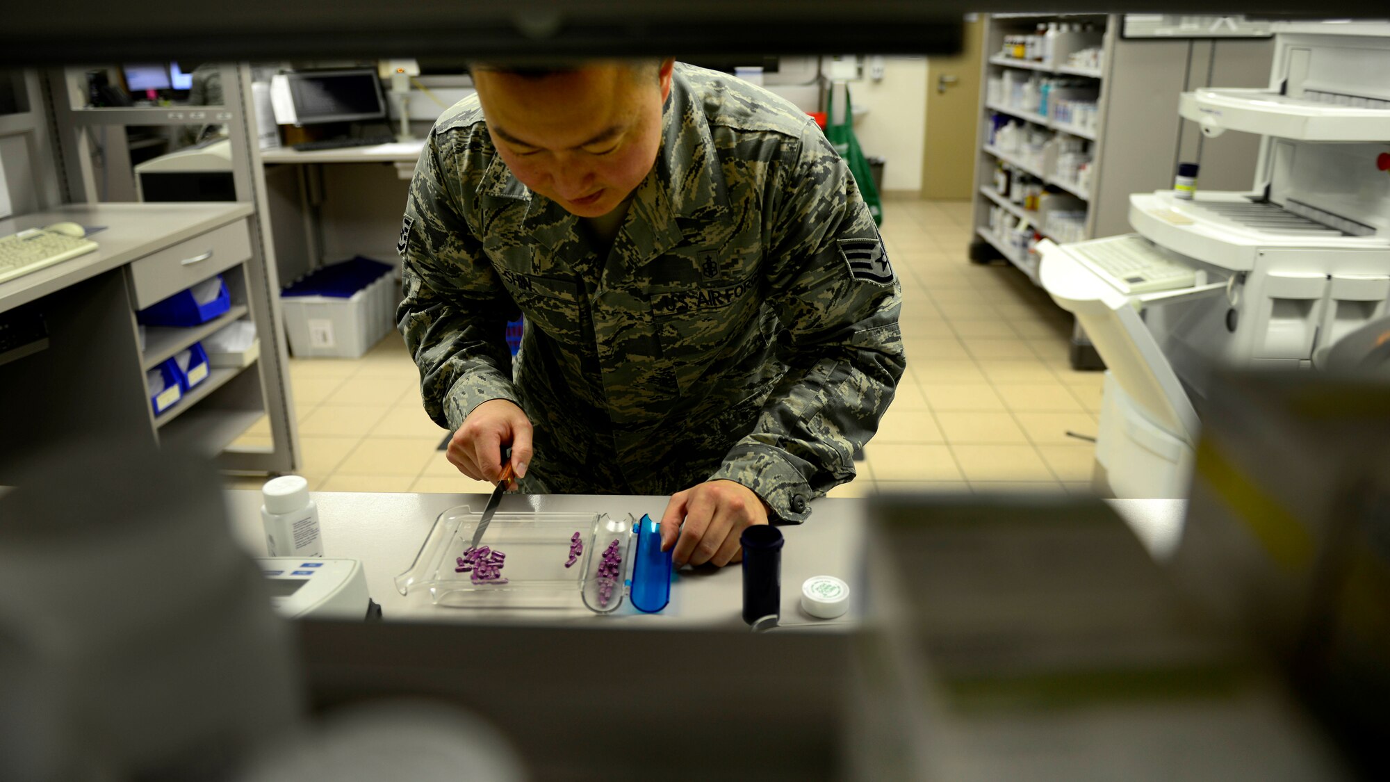 U.S. Air Force Staff Sgt. Charles Shin, 31st Medical Support Squadron Pharmacy technician, fills a prescription, Aug. 31, 2015, at Aviano Air Base, Italy. The pharmacy fills more than 200 prescriptions a day. (U.S. Air Force photo by Senior Airman Areca T. Wilson/Released)