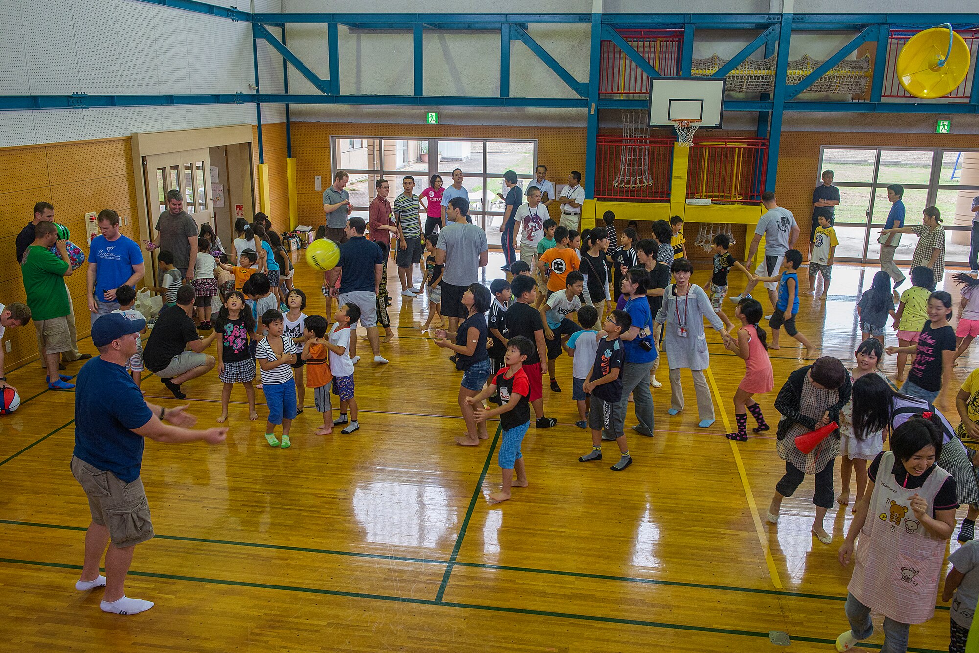 U.S. Air Force members from the 44th Fighter Squadron and 44th Aircraft Maintenance Unit play with school age children at the Chikujo Youth Center in Chikujo Town, Japan, Aug. 29, 2015. Members from the 18th Wing temporarily deployed to Tsuiki, Japan, to participate in Aviation Training Relocation to practice deployed operations and perform bilateral training in a joint environment alongside the Japan Air Self-defense Force’s 8th Air Wing. During the ATR, members also participated in numerous community outreach events as well as visited nearby schools and daycares in order to build ties with the local community. The groups played vollyball, soccer, basketball and several other games with students during their recess. (U.S. Air Force photo by Senior Airman Stephen G. Eigel)