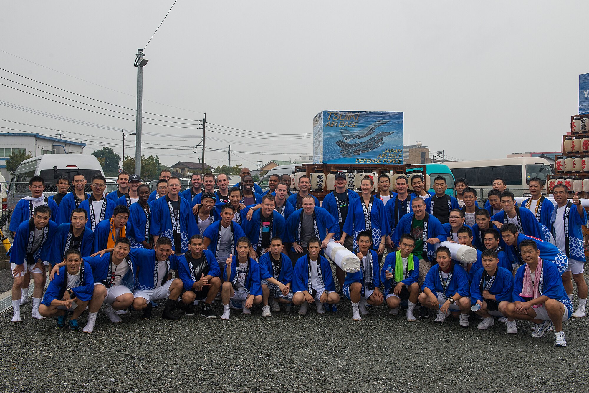U.S. Air Force members from the 44th Fighter Squadron and 44th Aircraft Maintenance Unit along with members of the Japan Air Self-Defense Force pose for a group photo after carrying an Omikoshi (portable shrine) during a parade in Yukuhashi City, Japan, Aug. 29, 2015. The U.S. Airmen are all deployed from Kadena Air Base, Japan, to participate in a two-week Aviation Training Relocation to help build interoperablitiy between the two forces. While temorarily deployed, the Airmen also interacted with the local community by volunteering at daycares and schools in the area and participating in numerous community outreach events. (U.S. Air Force photo by Senior Airman Stephen G. Eigel)