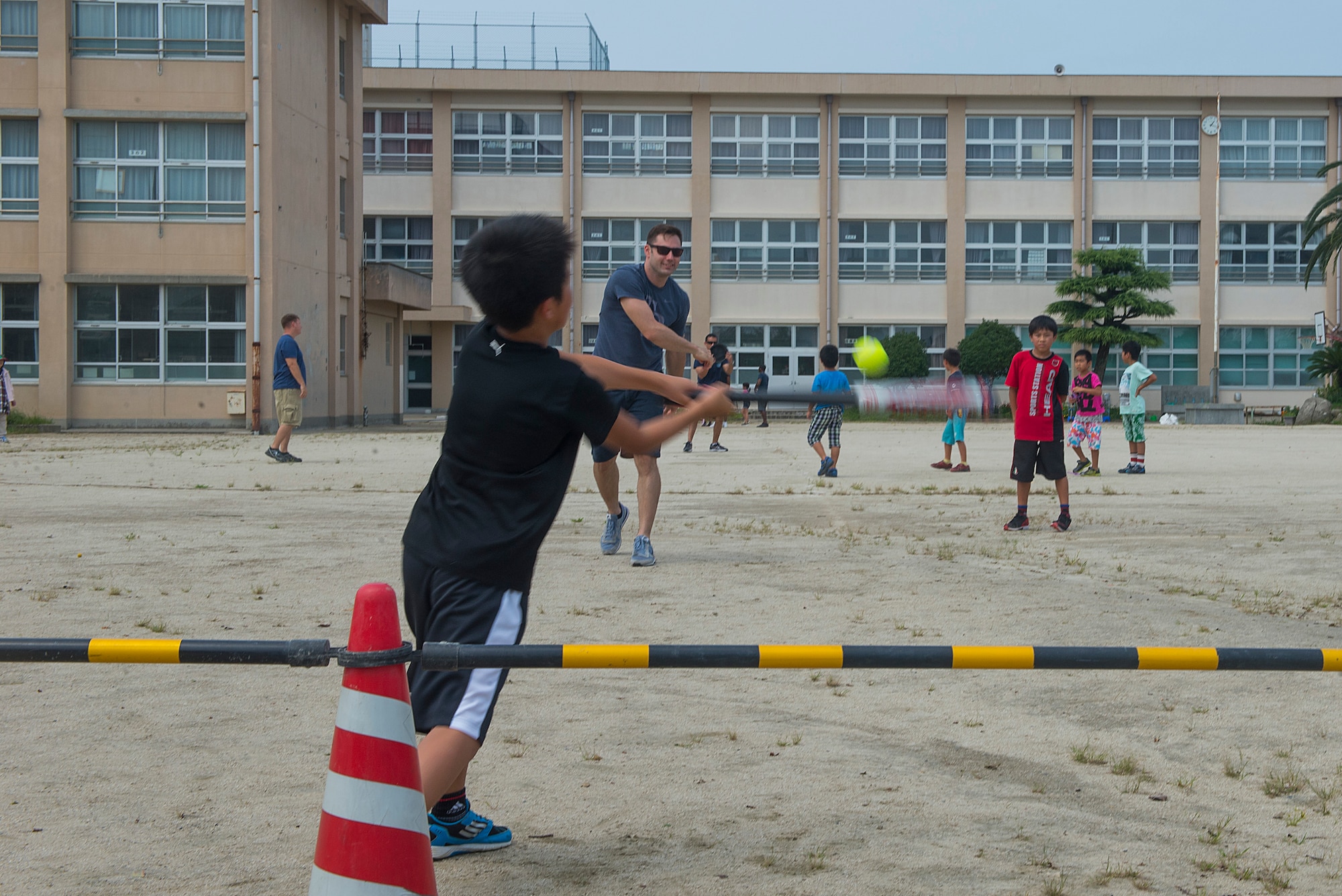 U.S. Air Force Staff Sgt. Nathan Dowling, 18th Maintenance Group UDM, plays baseball with children at Nakatsu Elementary School in Yukuhashi City, Japan, Aug. 28, 2015. Members from the 18th Wing temporarily deployed to Tsuiki, Japan, to participate in Aviation Training Relocation to practice deployed operations and perform bilateral training in a joint environment alongside the Japan Air Self-defense Force’s 8th Air Wing. During the ATR, members also participated in numerous community outreach events as well as visited nearby schools and daycares in order to build ties with the local community. (U.S. Air Force photo by Senior Airman Stephen G. Eigel)