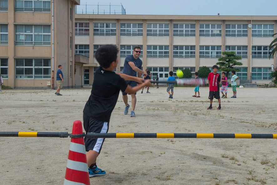 U.S. Air Force Staff Sgt. Nathan Dowling, 18th Maintenance Group unit deployment manager, plays baseball with children at Nakatsu Elementary School in Yukuhashi City, Japan, Aug. 28, 2015. Members from the 18th Wing temporarily deployed to Tsuiki, Japan, to participate in Aviation Training Relocation to practice deployed operations and perform bilateral training in a joint environment alongside the Japan Air Self-Defense Force’s 8th Air Wing. During the ATR, members also participated in numerous community outreach events as well as visited nearby schools and daycares in order to build ties with the local community. (U.S. Air Force photo by Senior Airman Stephen G. Eigel)
