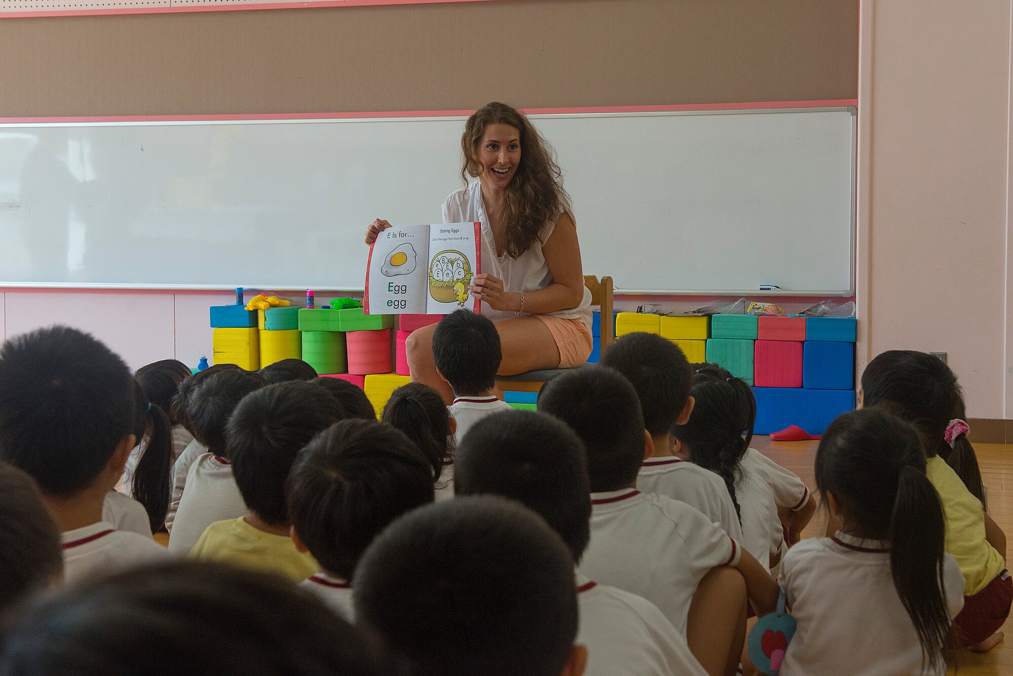 U.S. Air Force Staff Sgt. Leiah Cooper, 44th Aircraft Maintenance Unit debreifer, reads a book to children at Toyotsu day care, Miyako town, Japan, Aug. 28, 2015. Members of the 44th visited three school as well as participated in a sumer festival parade during their time in Yukuhashi for an Aviation Training Relocation event. The United States and its military forces are committed to the continued defense of Japan and maintenance of regional peace and stability. Through ATRs, the U.S. Air Force and Japan Air Self-Defense Force strengthen the Japan-U.S. alliance and each service’s ability to respond to a threat or crisis in the region. (U.S. Air Force photo by Senior Airman Stephen G. Eigel)