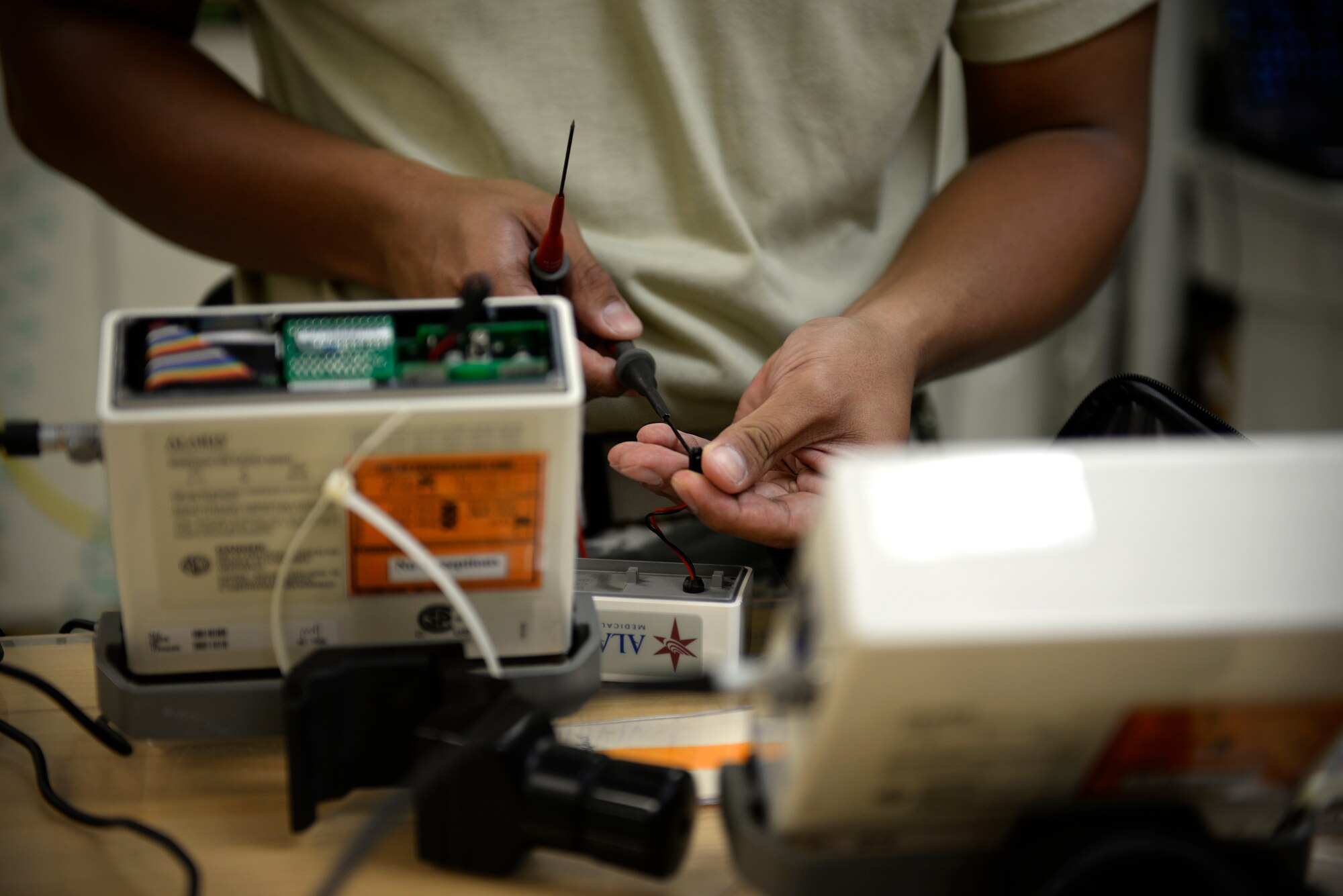 Tech. Sgt. Virgilio Biascan, 36th Medical Support Squadron NCO in charge of biomedical equipment maintenance, tests an internal battery of an infusion pump Aug. 25, 2015, at Andersen Air Force Base, Guam. Biomedical equipment technicians are responsible for maintenance of all medical equipment used on base. (U.S. Air Force photo by Staff Sgt. Alexander W. Riedel/Released)