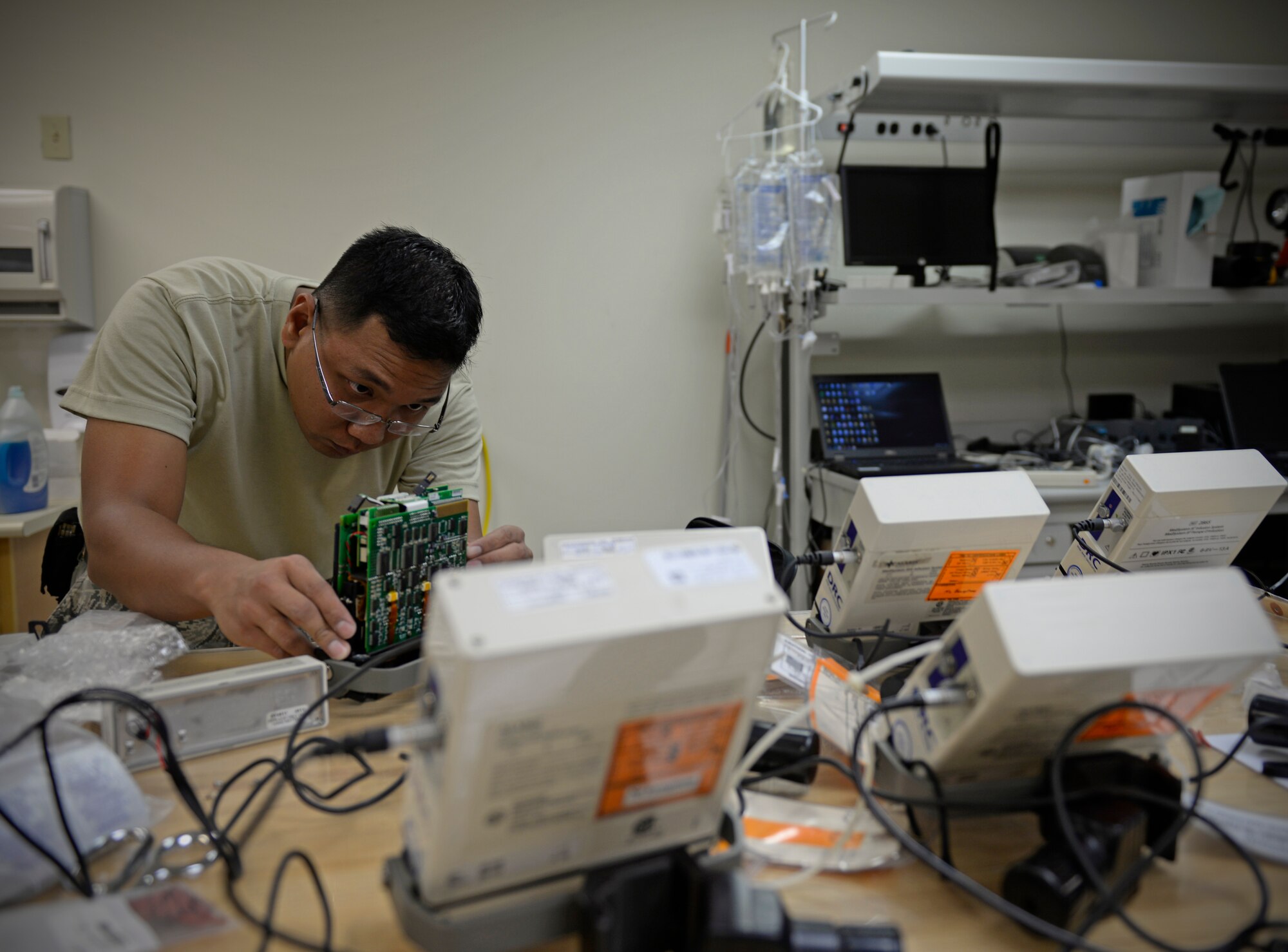Tech. Sgt. Virgilio Biascan, 36th Medical Support Squadron NCO in charge of biomedical equipment maintenance, reviews internal electrical connections on an infusion pump Aug. 25, 2015, at Andersen Air Force Base, Guam.  Biomedical equipment technicians are responsible for maintenance of all medical equipment used on base. (U.S. Air Force photo by Staff Sgt. Alexander W. Riedel/Released)